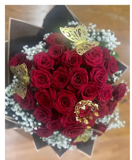 Red roses with baby breath in our FANCY wrap
